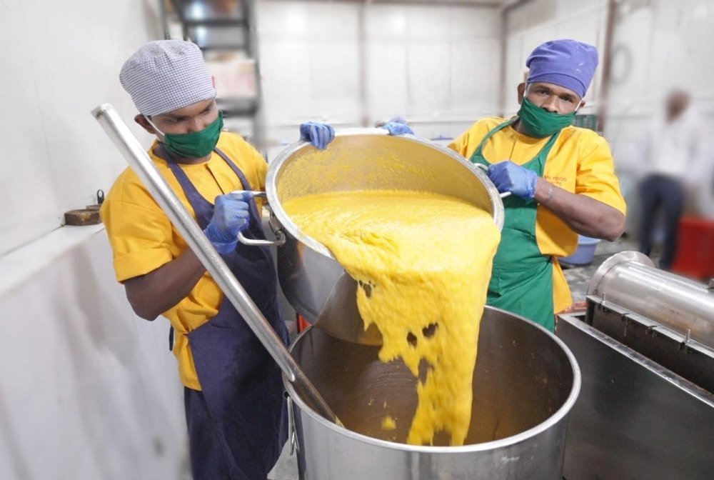 Mango pulp being poured during processing